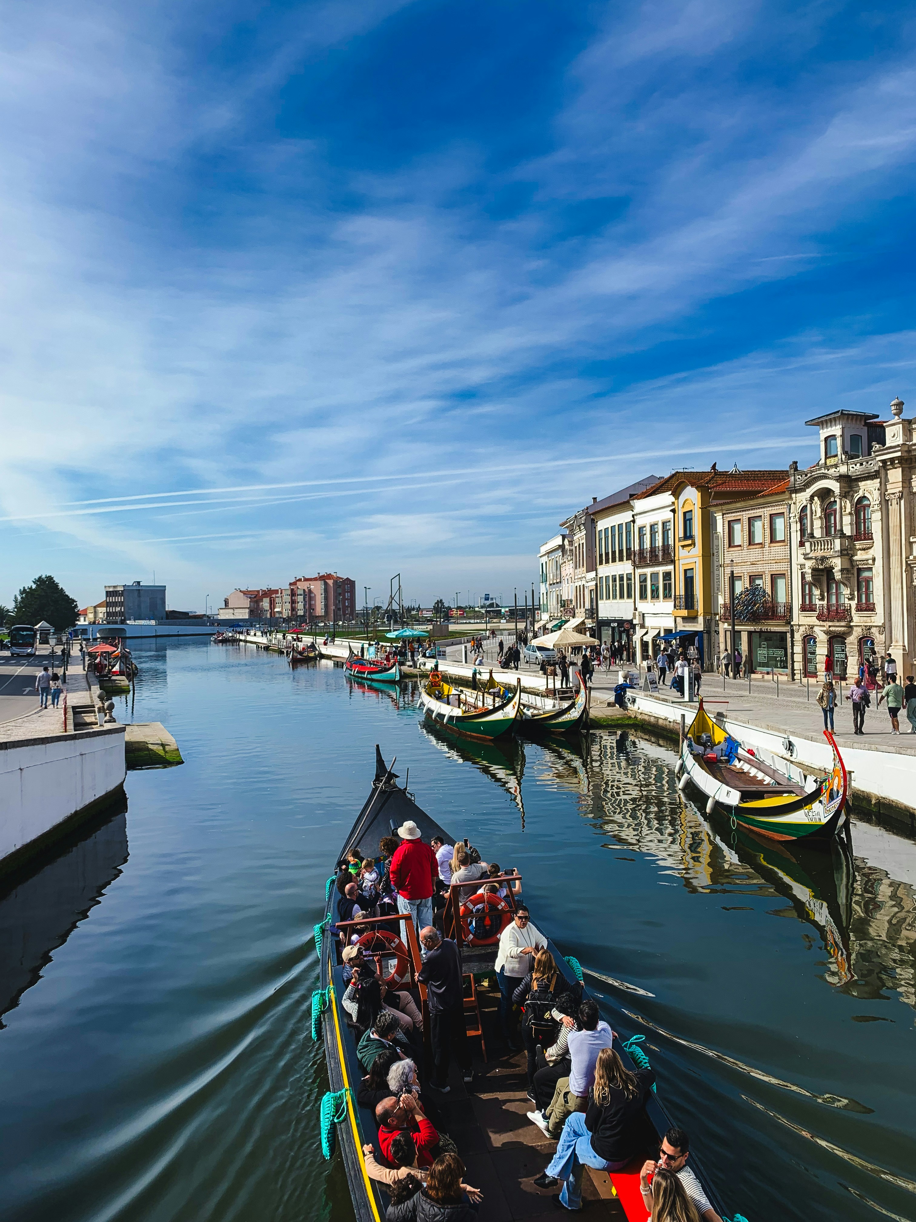 Aveiro waterfront canal with traditional boats and colourful buildings