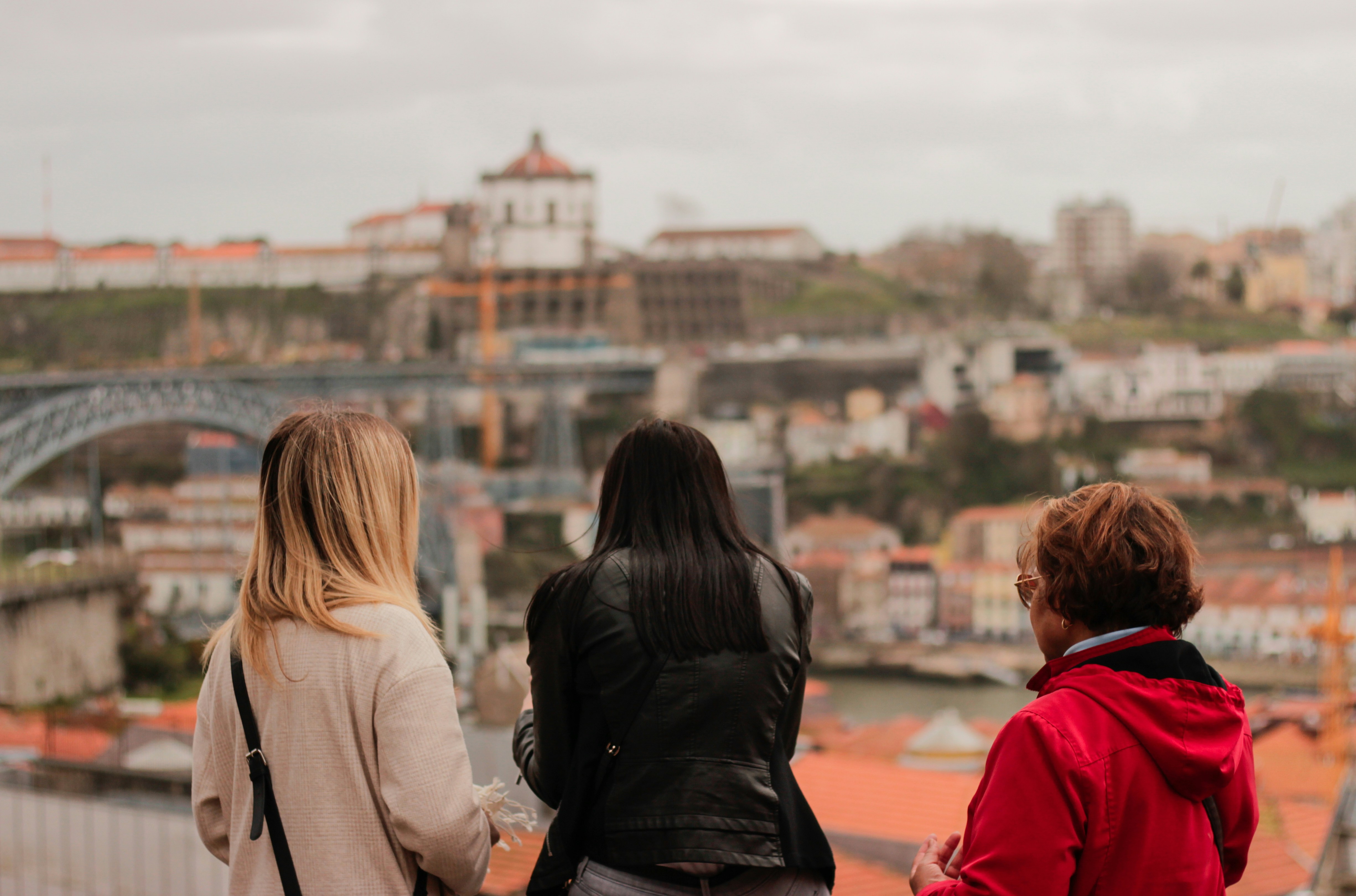 Visitors admiring the Porto skyline and Dom Luís I Bridge from a viewpoint