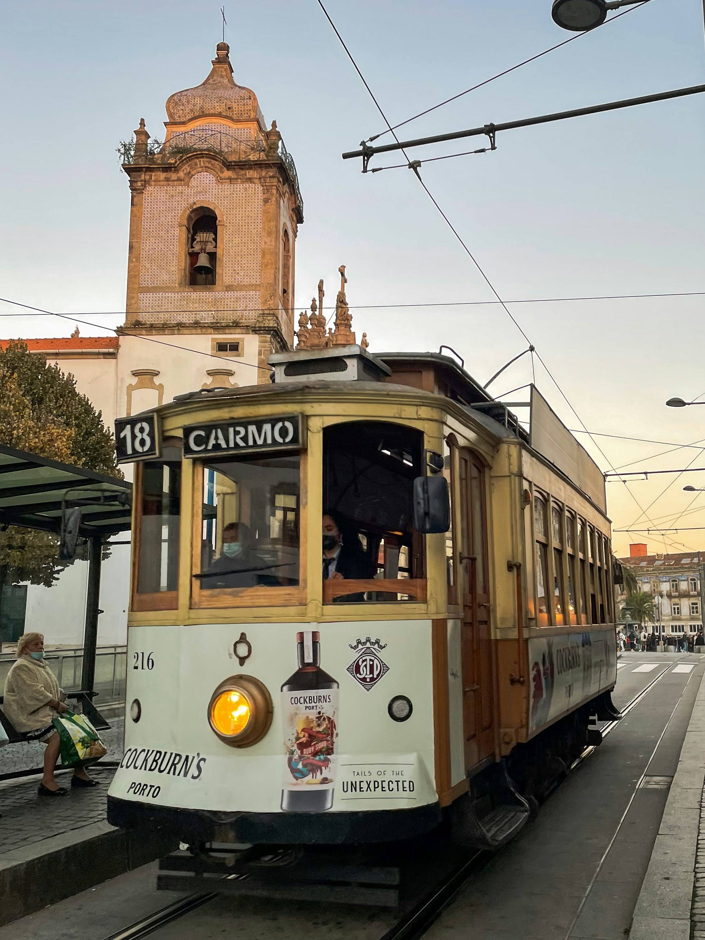 Porto tram line 18 to Carmo with church tower at sunset