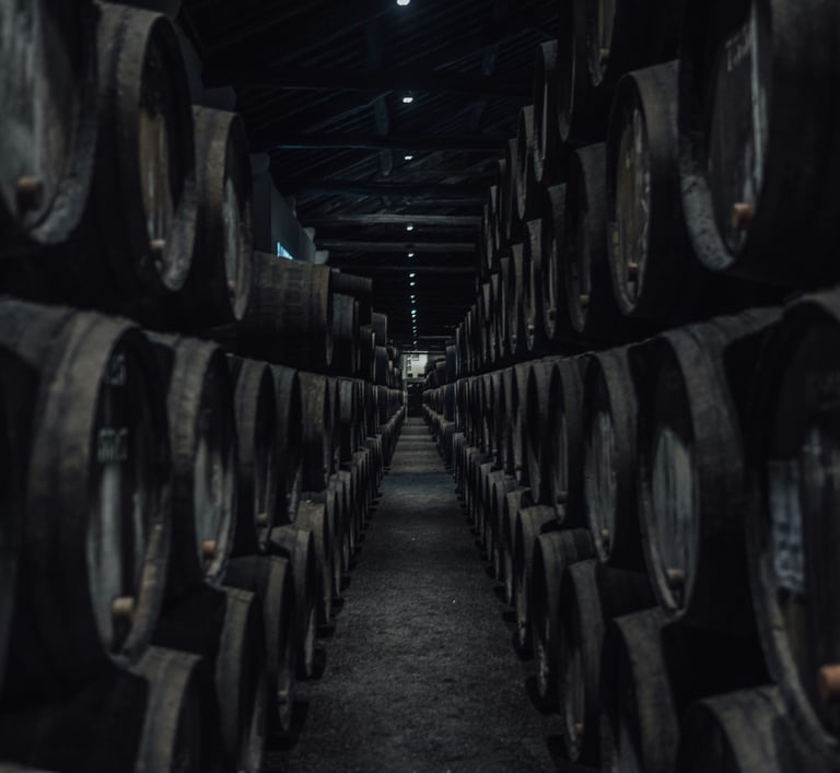 Interior of a Port wine cellar with oak barrels and wine glasses
